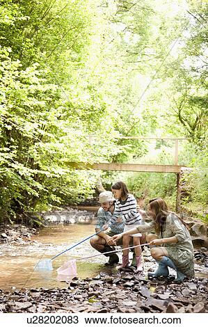 Family playing with nets in stream View Large Photo Image Stock Image - Family playing with nets in stream. Fotosearch