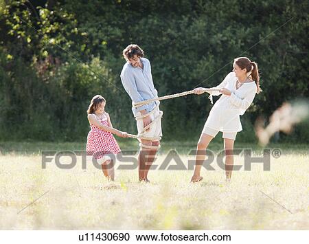 Family playing with rope in field View Large Photo Image Stock Image - Family playing with rope in field. Fotosearch
