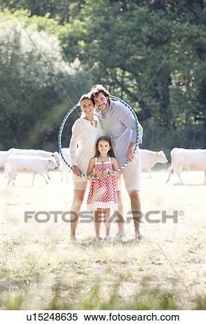 Family portrait with hoop in field View Large Photo Image Stock Photography - Family portrait with hoop in field. Fotosearch