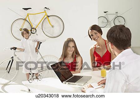 Stock Photo - family shopping in bikestore. Fotosearch