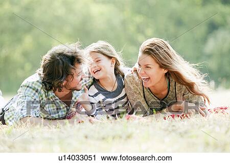 Family sitting on blanket in countryside View Large Photo Image Stock Image - Family sitting on blanket in countryside. Fotosearch