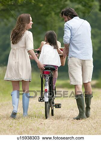Family walking in country with bike View Large Photo Image Stock Image - Family walking in country with bike. Fotosearch