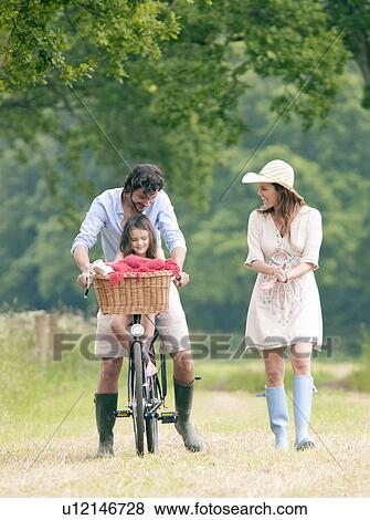 Family walking in country with bike View Large Photo Image Stock Photo - Family walking in country with bike. Fotosearch