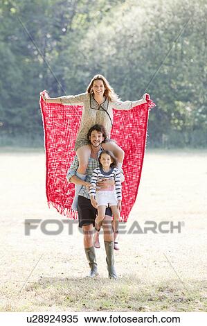 Family with red blanket in country field View Large Photo Image Stock Photography - Family with red blanket in country field. Fotosearch