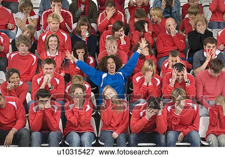 Stock Photo - Fan amongst rivals at football match. Fotosearch