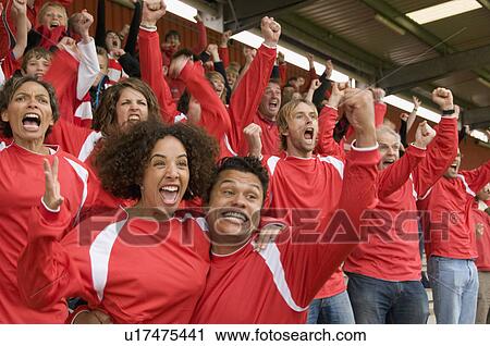 Stock Image - Fans celebrating at at football match. Fotosearch