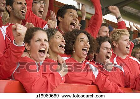 Stock Photo - Fans celebrating at football match. Fotosearch