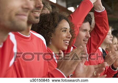 Stock Photography - Fans clapping at football match. Fotosearch