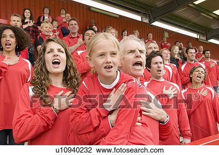 Fans singing anthem at football match View Large Photo Image Stock Image - Fans singing anthem at football match. Fotosearch