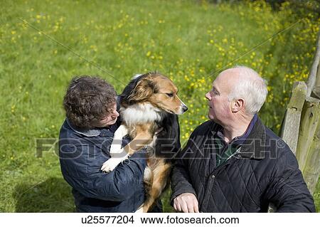 Picture - Farmer and wife with sheepdog. Fotosearch