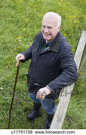 Farmer leaning on fence View Large Photo Image Stock Photo - Farmer leaning on fence. Fotosearch