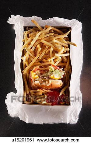 Stock Image - Fast food in take out box on paper bag. Fotosearch