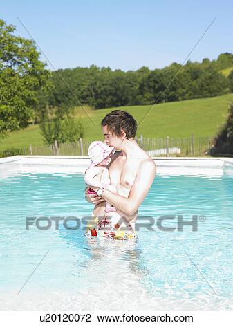 Stock Image - father and baby in pool. Fotosearch