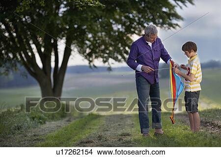 father and son building kite View Large Photo Image Picture - father and son building kite. Fotosearch