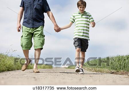 Father and son walking down a road View Large Photo Image Stock Photography - Father and son walking down a road. Fotosearch
