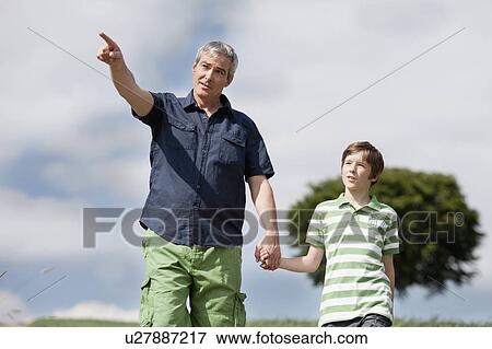 Father and son walking together View Large Photo Image Stock Photo - Father and son walking together. Fotosearch