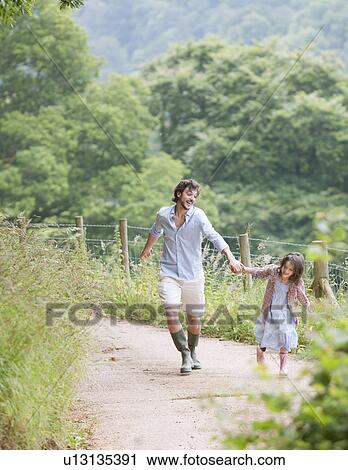 Stock Image - Father pulled up lane by daughter. Fotosearch