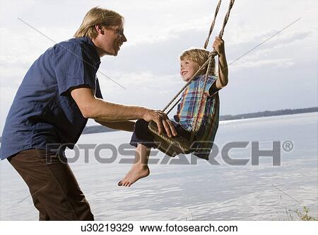 father with son on swing View Large Photo Image Stock Photo - father with son on swing. Fotosearch