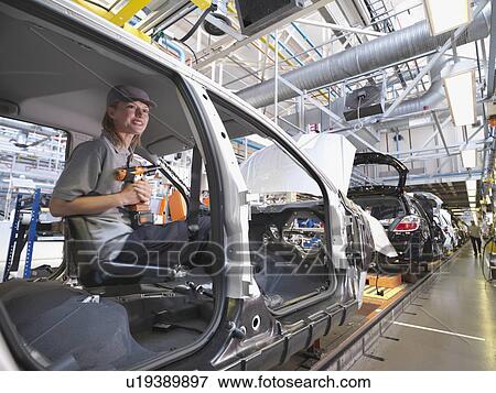 Stock Photo - Female Car Worker On Production Line. Fotosearch