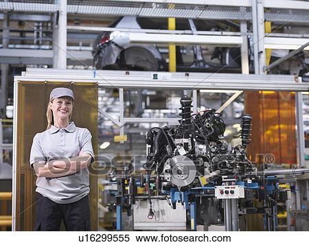 Stock Photography - Female Car Worker With Car Parts. Fotosearch