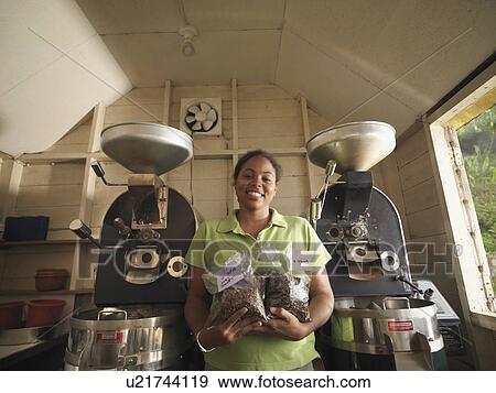 Stock Photo - Female Coffee Worker With Packaged Beans. Fotosearch