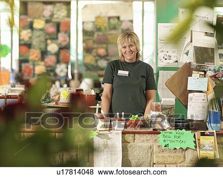 Female Garden Center Worker Behind Till View Large Photo Image Stock Photo - Female Garden Center Worker Behind Till. Fotosearch