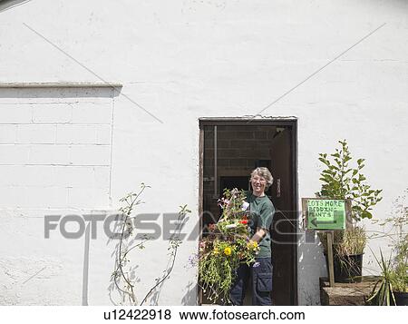 Female Garden Center Worker With Plant View Large Photo Image Stock Photo - Female Garden Center Worker With Plant. Fotosearch