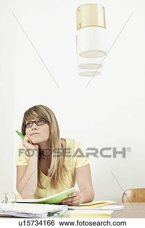 Female student sitting at table View Large Photo Image Stock Photograph - Female student sitting at table. Fotosearch