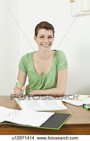 Picture - Female student with papers. Fotosearch