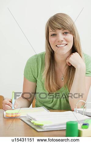 Stock Image - Female student with papers. Fotosearch