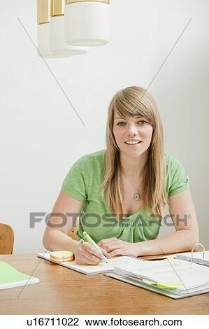Stock Image - Female student with papers. Fotosearch