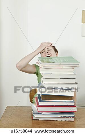 Picture - Female student with stack of books. Fotosearch