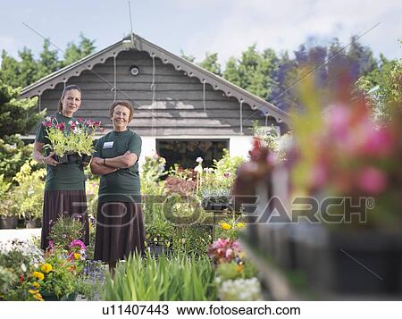 Stock Image - Female Workers At Garden Center. Fotosearch