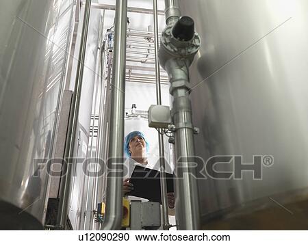 Stock Image - Food Worker Checking Instrumentation. Fotosearch