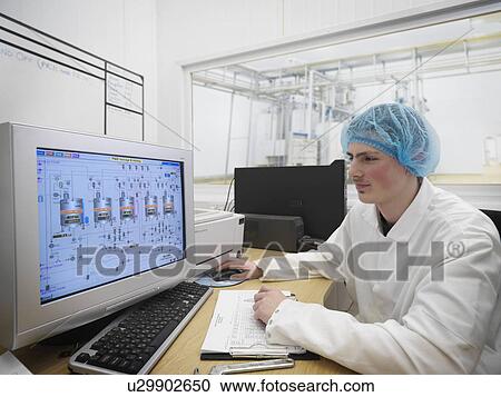 Stock Image - Food Worker With Data On Computer. Fotosearch