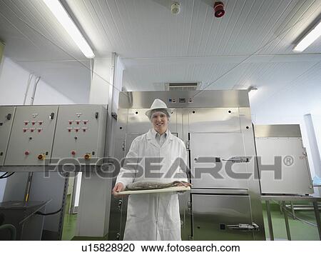 Stock Image - Food Worker With Fish On Board. Fotosearch