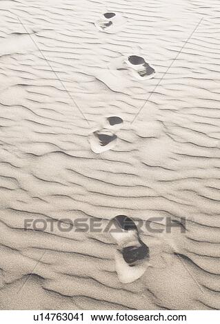 Stock Image - Footprints in sand. Fotosearch