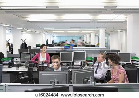 Four colleagues chatting at work View Large Photo Image Picture - Four colleagues chatting at work. Fotosearch