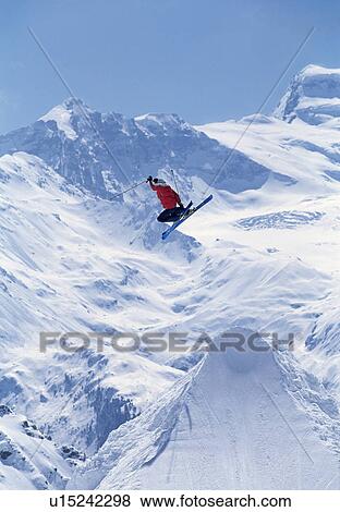 Freestyle skier jumping into the air View Large Photo Image Stock Photo - Freestyle skier jumping into the air. Fotosearch