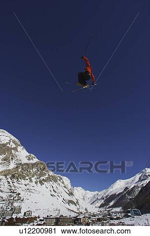 Freestyle skier jumping through the air. View Large Photo Image Stock Image - Freestyle skier jumping through the air.. Fotosearch