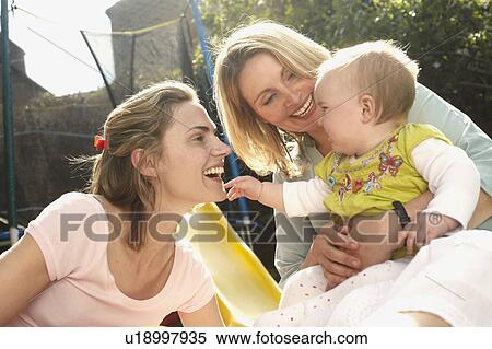 Stock Photography - friends and baby. Fotosearch