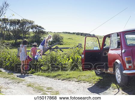 Friends climbing into a field View Large Photo Image Stock Photo - Friends climbing into a field. Fotosearch