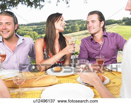 friends having dinner outside View Large Photo Image Stock Photo - friends having dinner outside. Fotosearch