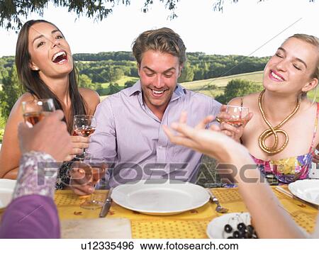 friends having dinner outside View Large Photo Image Stock Photograph - friends having dinner outside. Fotosearch