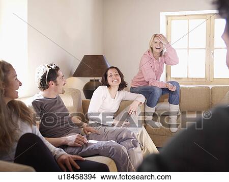 friends laughing in chalet living room View Large Photo Image Picture - friends laughing in chalet living room. Fotosearch