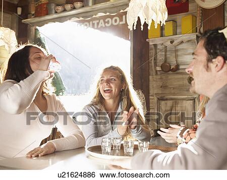 friends laughing in ski lodge bar View Large Photo Image Stock Photograph - friends laughing in ski lodge bar. Fotosearch