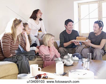 friends laughing with cake in chalet View Large Photo Image Stock Image - friends laughing with cake in chalet. Fotosearch