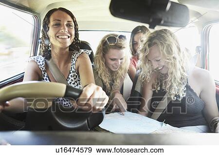 Friends packing a car View Large Photo Image Stock Photo - Friends packing a car. Fotosearch