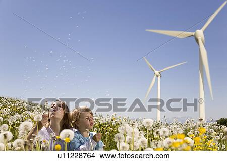 Girl and boy at wind turbine View Large Photo Image Picture - Girl and boy at wind turbine. Fotosearch