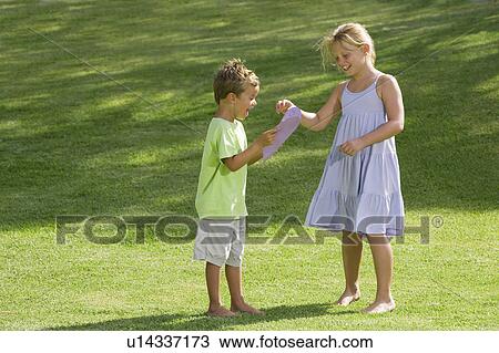 Girl giving boy a paper heart View Large Photo Image Stock Image - Girl giving boy a paper heart. Fotosearch
